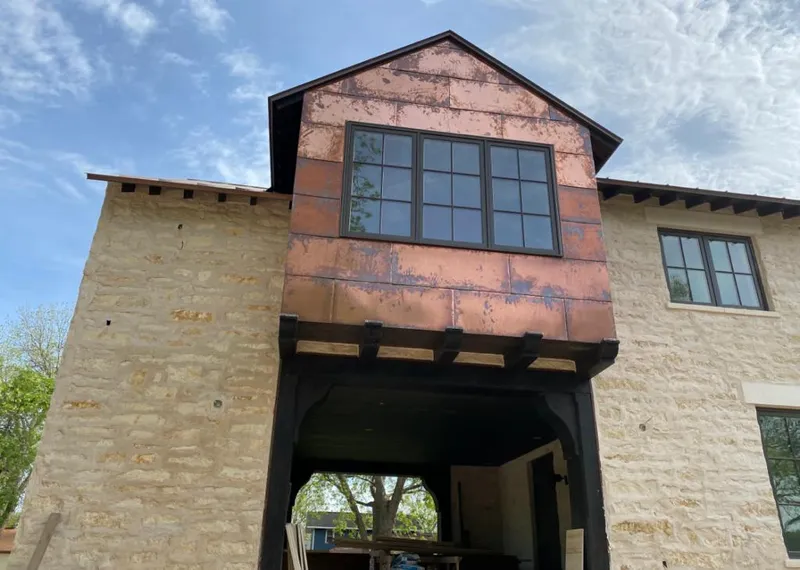 Copper metal panel facade on a stone building for Skylight Installation in Pendleton
